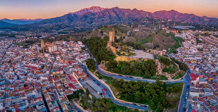 Aerial view of a town with a castle and mountains in Spain