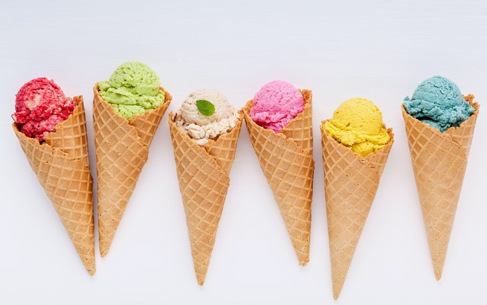 Assortment of colorful ice cream cones on a white background