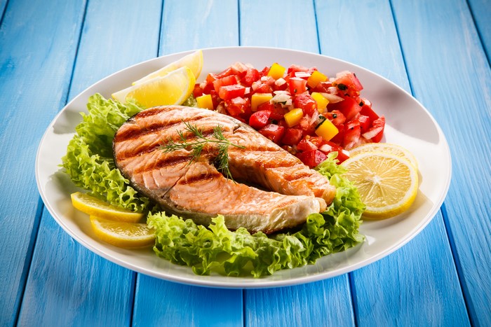 Grilled Salmon Steak with Salad and Lemon