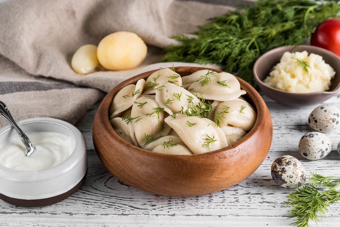 Pierogi with dill, sour cream, and mashed potatoes