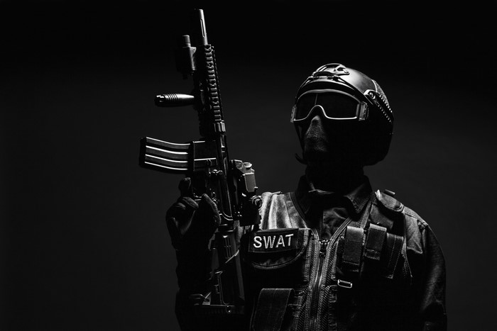SWAT officer holding an assault rifle