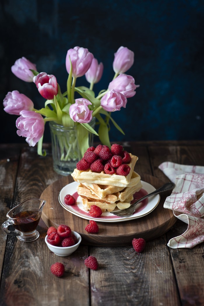 Waffles with raspberries and tulips
