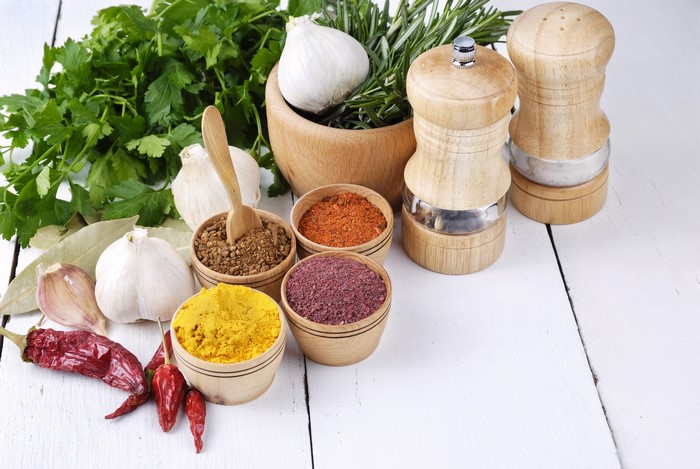 Spices, Garlic, and Chili Peppers on Wood Planks