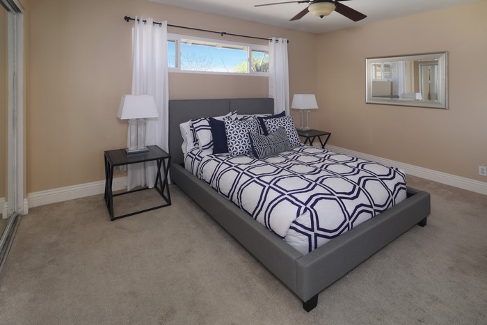 Bedroom with a bed, nightstands, and a mirror