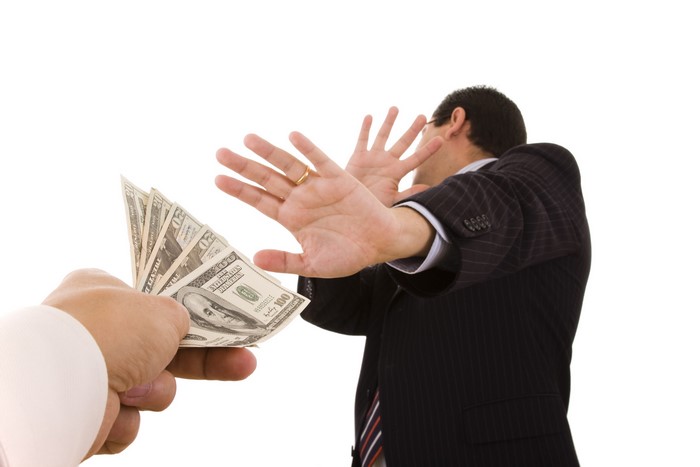 Man refusing money offered by another hand