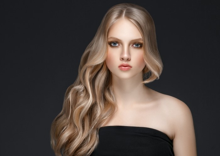 Blonde woman with wavy hair and blue eyes