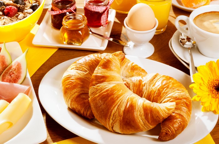 Breakfast with Croissants, Eggs, and Fruit