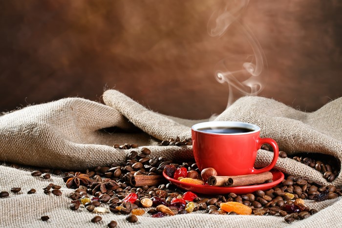 Coffee cup with beans and spices
