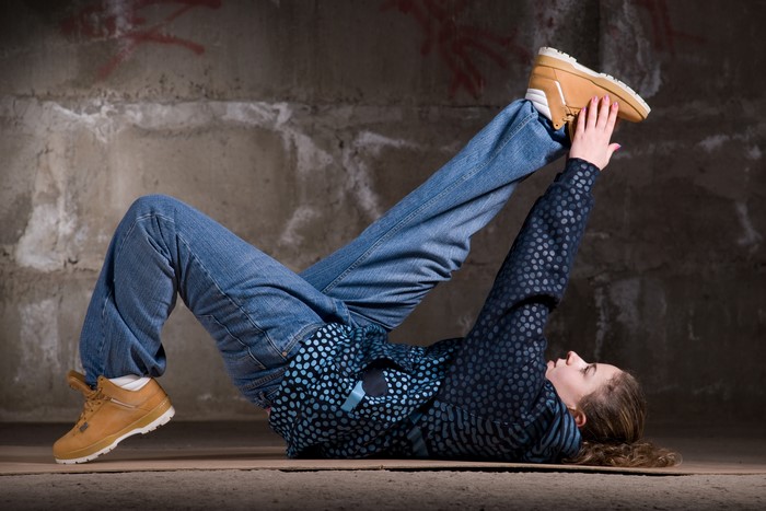 Woman dancing in jeans and boots
