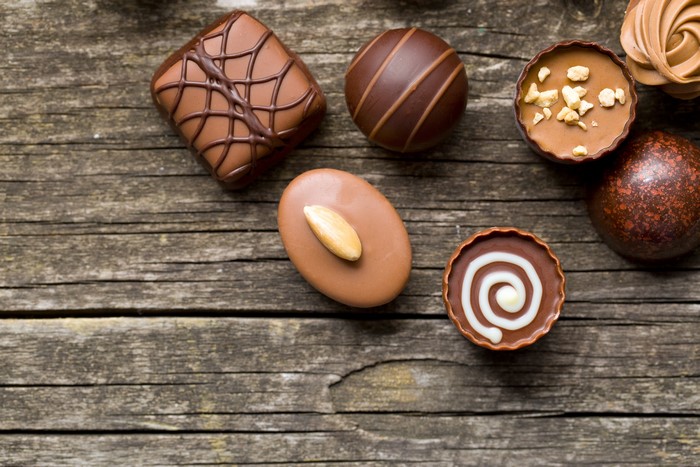 Assortment of chocolates on wooden planks