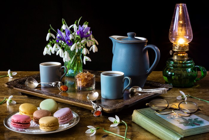 Cozy Still-Life with Snowdrops, Macarons, and Kerosene Lamp