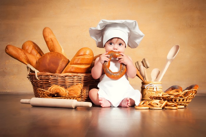 Adorable Baby Chef with Bread and Pastries