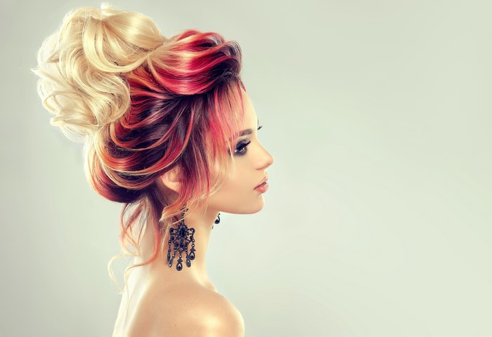 Woman with blonde and red hair, black earrings
