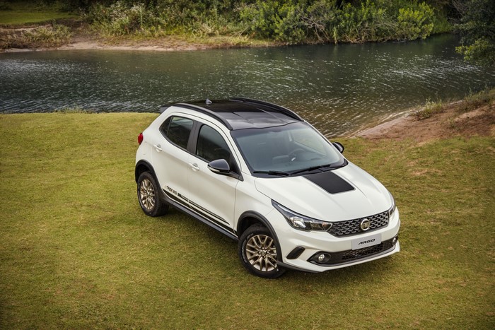 White Fiat Argo Trekking parked on grass by a river