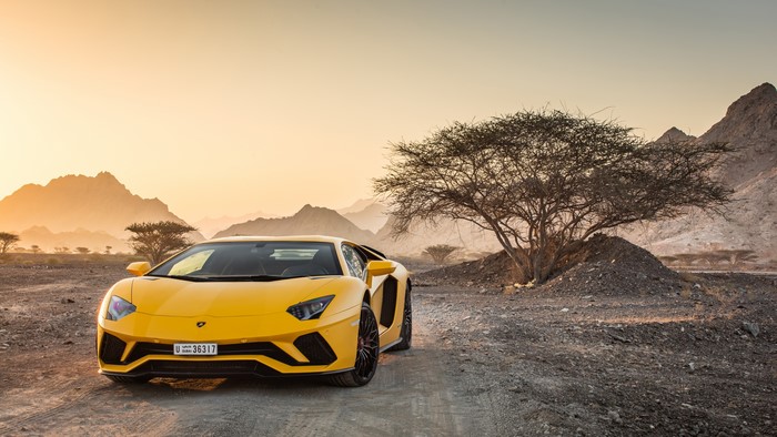 Yellow Lamborghini Aventador S in desert landscape