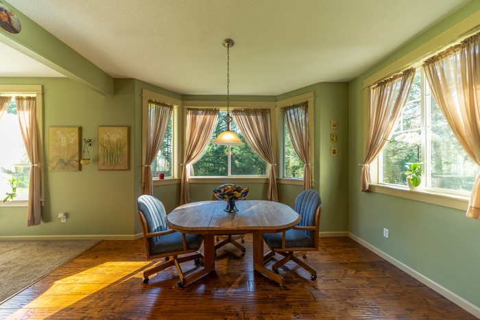 Dining room with table, chairs, and bay window