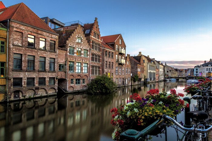 Canal in Gent, Belgium with historic houses and flowers