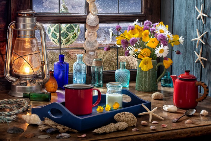 Still-life with Kerosene lamp, flowers, and bottles