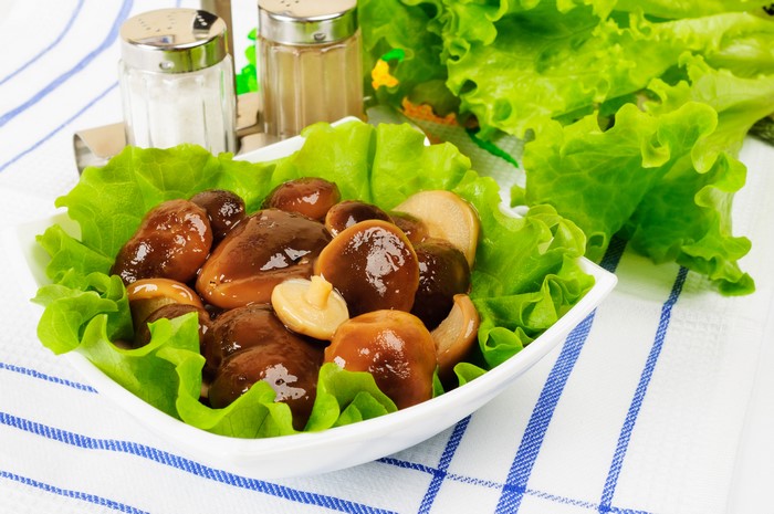 Marinated mushrooms with lettuce and salt and pepper shakers