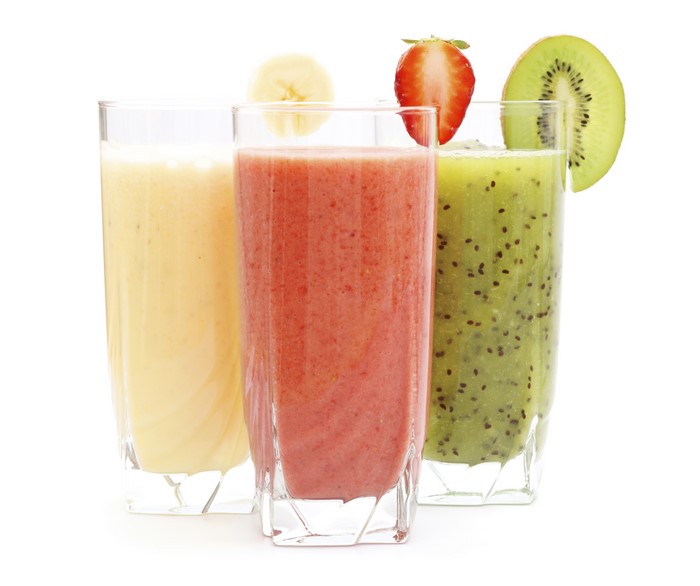 Three fruit smoothies in highball glasses