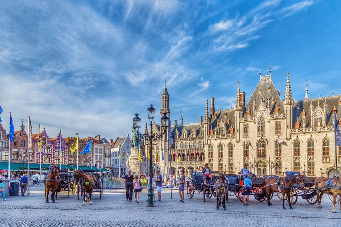 Horse-drawn carriages in Bruges town square, Belgium