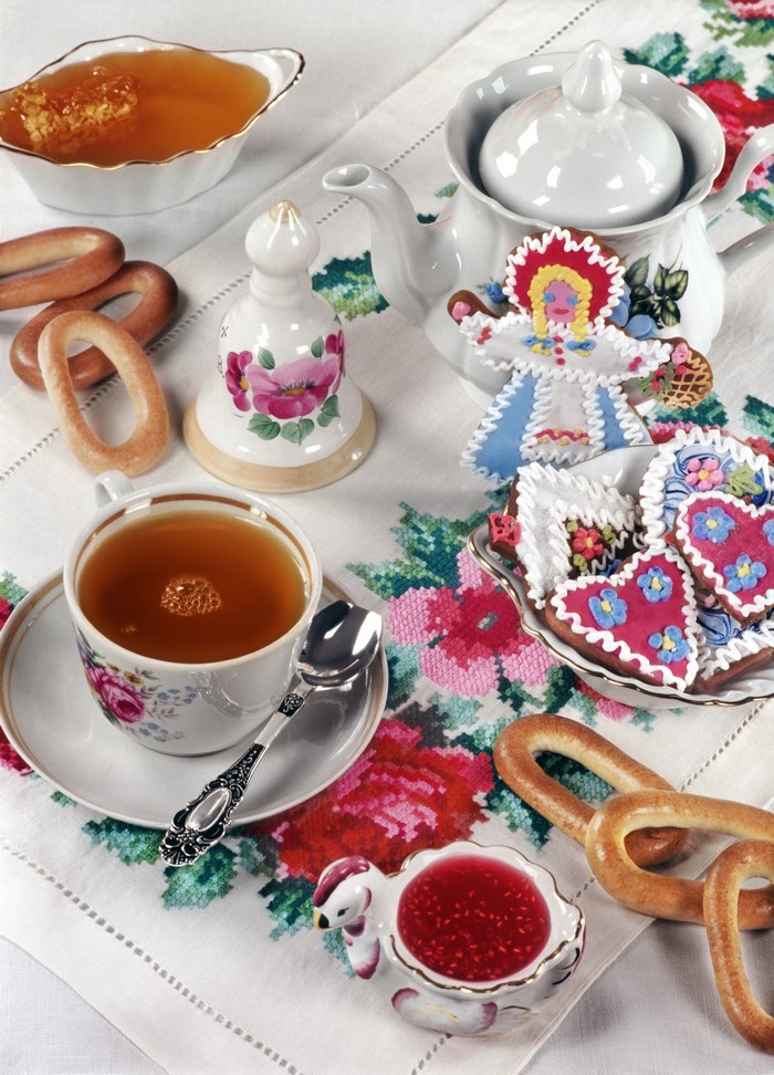 Tea set with honey, jam, cookies, and bagels