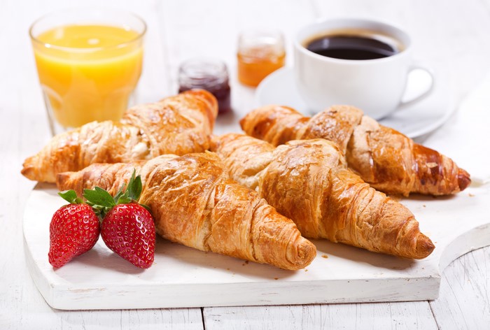 Croissants with Coffee, Orange Juice, and Strawberries