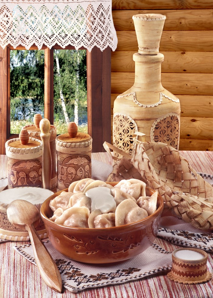 Still-life of Pelmeni with Sour Cream and Wooden Utensils