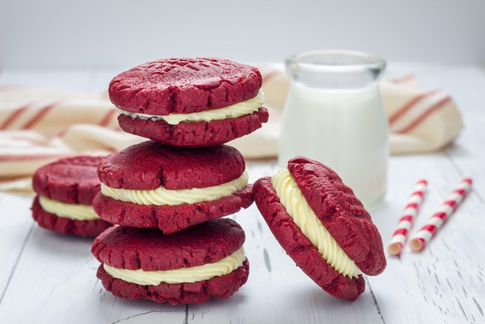 Red velvet cookies with cream filling and milk