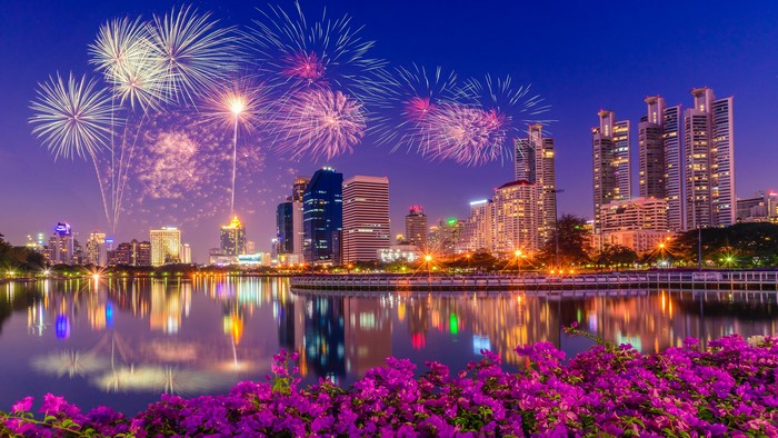 Fireworks over a city skyline at night