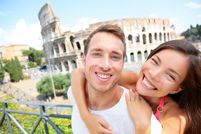 Couple hugging in front of the Colosseum in Rome