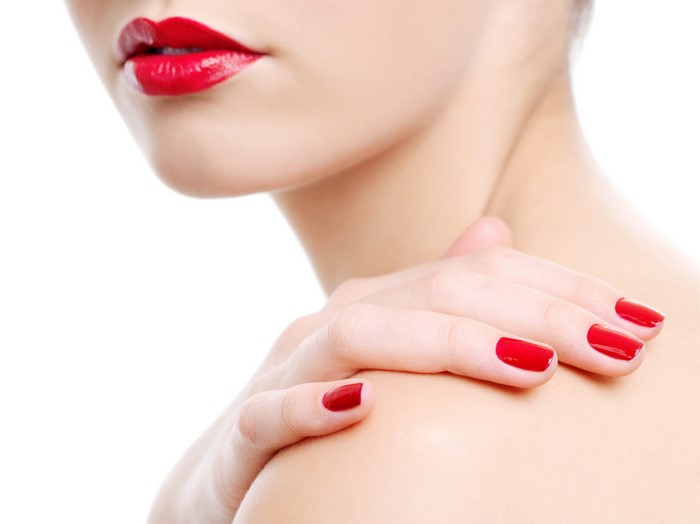 Woman with red lips and red manicure