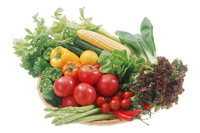 Basket of fresh vegetables including tomatoes, peppers, corn, and lettuce