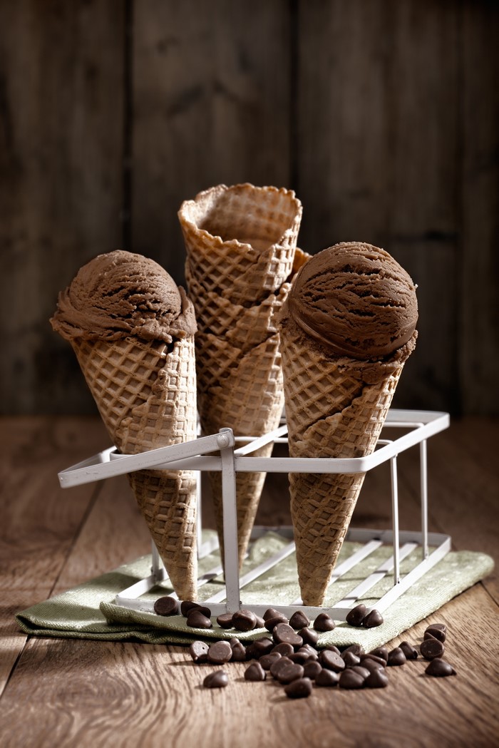 Chocolate ice cream cones in a holder with chocolate chips