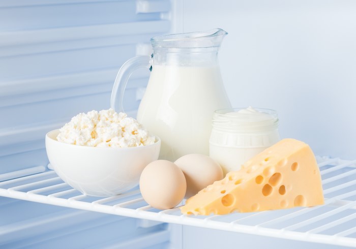 Milk, Cheese, Quark, Eggs, and Cream in a Refrigerator
