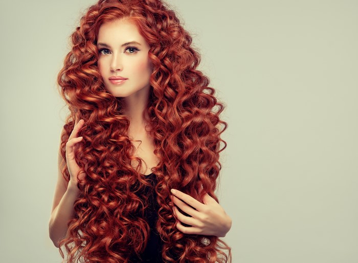 Redhead girl with long curly hair