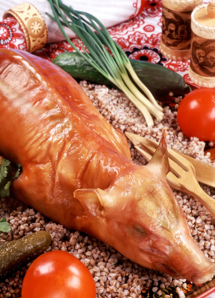 Whole roasted pig with vegetables and buckwheat