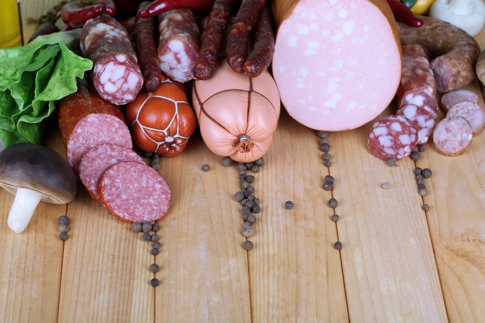 Assortment of sausages and meat products on wood planks