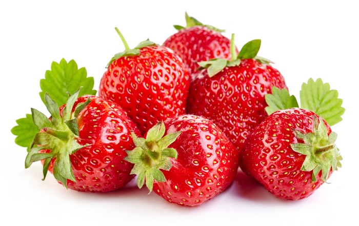 Strawberries with green leaves on white background