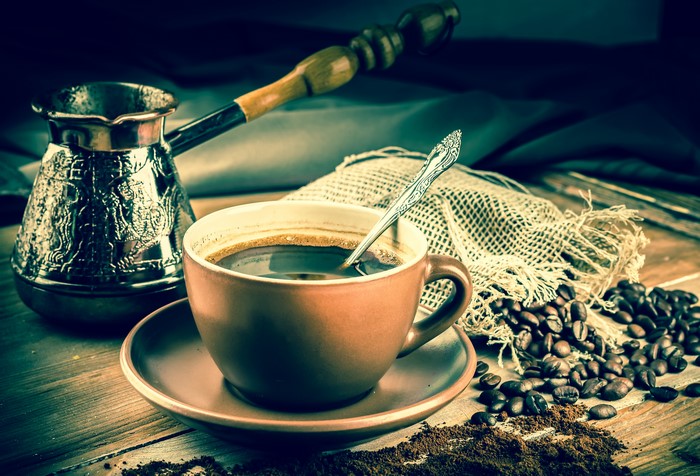 Coffee cup with cezve and coffee beans