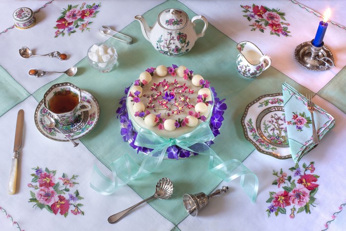 Tea set with cake, kettle, and candle