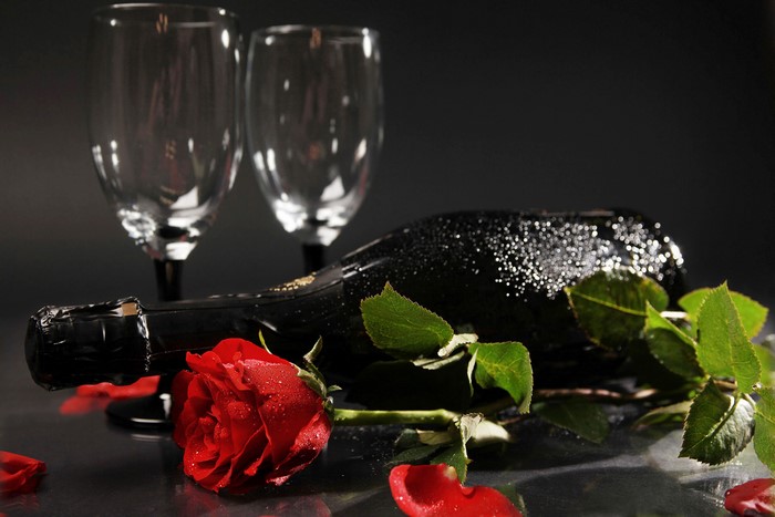 Champagne bottle with rose and glasses