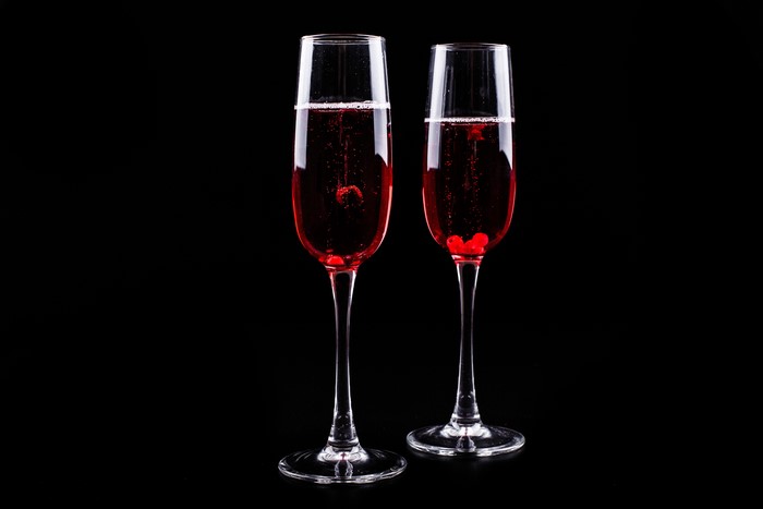 Two glasses of red wine with berries