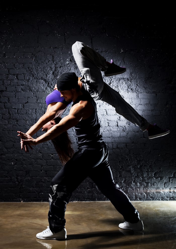 Two dancers performing an acrobatic move