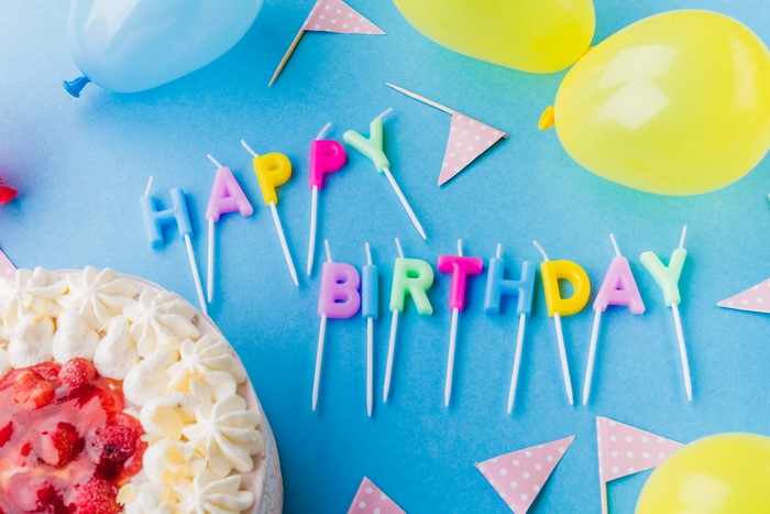 Birthday cake with candles and balloons