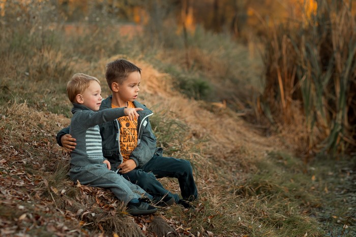 Two boys sitting on grass, Ekaterina Borisova