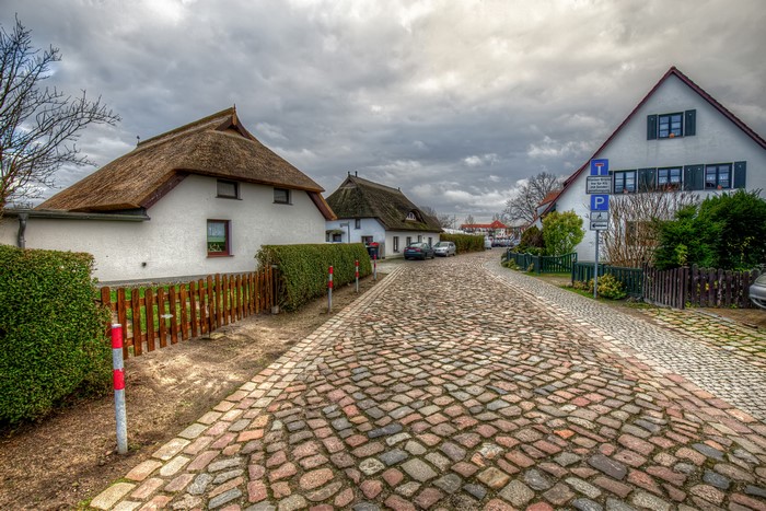 Cobblestone street in Wieck, Mecklenburg-Vorpommern, Germany with thatched-roof houses