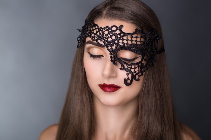 Woman with Black Lace Masquerade Mask and Red Lips