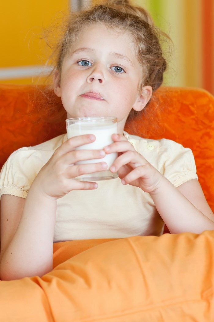 Girl holding a glass of milk