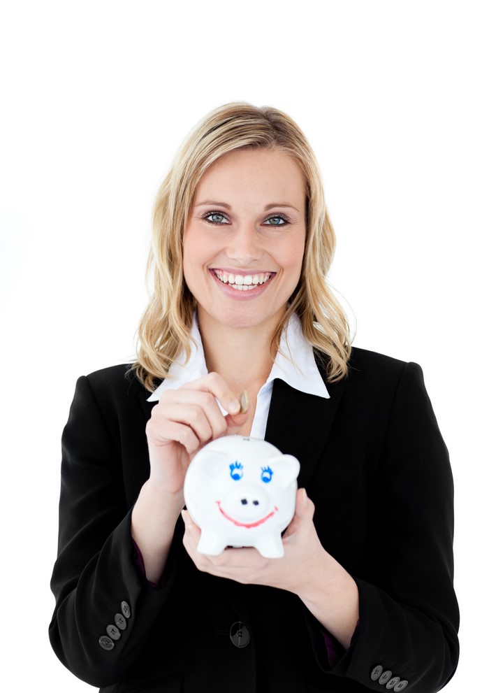 Blonde woman in a suit putting a coin in a piggy bank